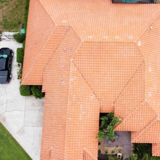 Aerial view of clean light terracotta tile roof after professional soft washing